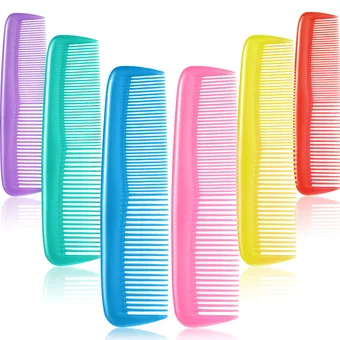 Rainbow row of plastic hair combs, seven colours side by side